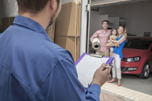 Professional removals service preparing furniture for transport